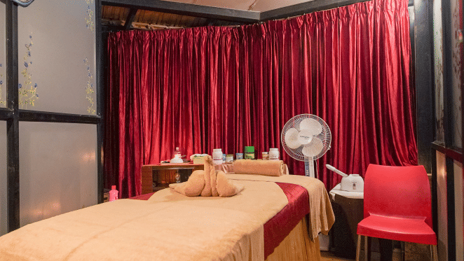 Image of a spa bed with a fan beside it at Coorg Jungle Camp Backwater Resort, Kushalnagar.